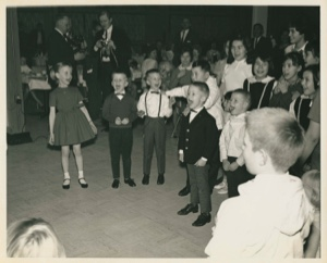 Image of Christmas party with children, others singing; Thule AFB