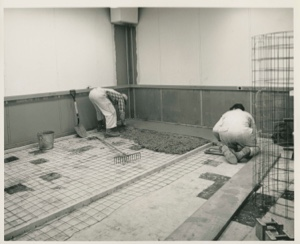 Image: Two men laying new floor, Thule AFB