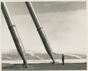 Image: Man standing by two antenna struts,