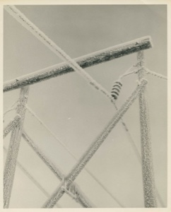Image of Detail, snow encrusted wires and connections on a low support, Thule AFB
