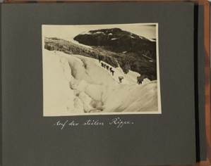 Image: Auf den steilen Rippe [On the steep rib: nine men climbing up glacier, carrying large loads on their backs]