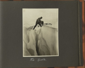 Image: Die Spalte [The Gap: Man on glacier using long sledge to straddle a cravass]