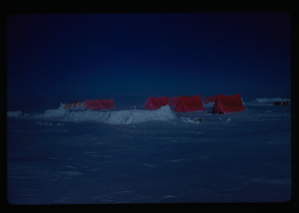 Image of Orange tents in the snow.
