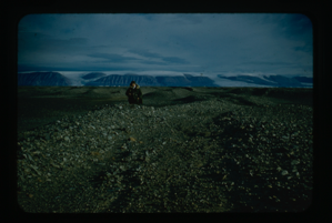 Image of Man standing on rocky plain