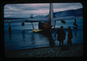 Image of Plane landed on the water, dinghy nearby