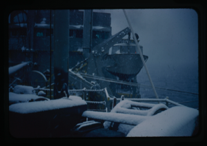 Image of Naval ship life boat suring snowfall.