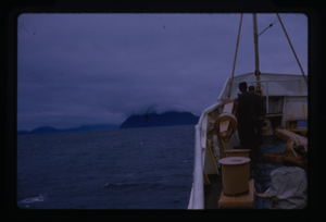 Image: People on deck, foggy mountain in distance