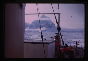 Image of Helicopter on ship deck, mountain in background