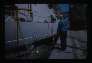 Image of Naval ship at dock recieving maintenance