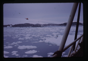 Image of Helicopter flying over drift ice