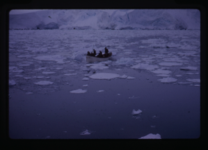 Image of Row boat moving through drift ice