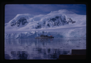 Image of Naval ship sailing near glacier