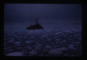 Image: Naval ship moving through drift ice.