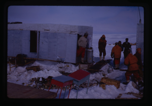 Image of Men in trailer-like shelters