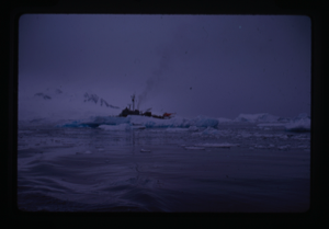 Image of Naval ship with helicopter partially hidden by ice floe