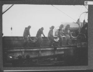 Image: Six Eskimos carrying meat on board the Roosevelt