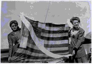 Image: Josephine and Marie Peary displaying Peary's American flag