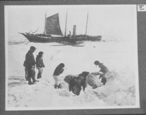 Image of Polar Eskimos and the Roosevelt crew on the ice. The Roosevelt in background, o