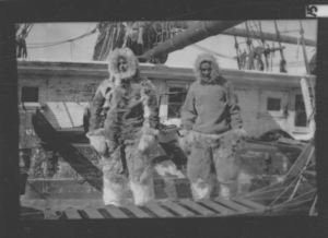 Image of MacMillan and Borup on deck, in furs, Battle Harbor, September 1909