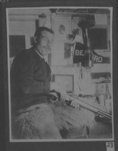 Image: [Bartlett] below deck with rifle, wearing polar bear pants [bedford pennant]