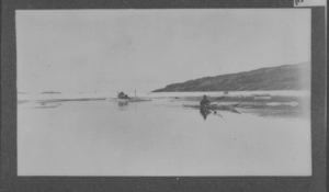Image of Sledge on ice floe and kayaker in water