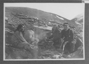 Image of Three Eskimos with Bartlett, ashore digging or cooking?