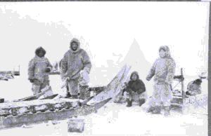 Image of John Goodsell and three Eskimos [Inuit] at tent with sledges (see notes)