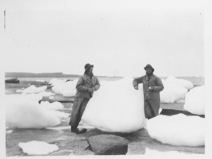 Image of [2 men leaning on giant snow balls - ice floes]