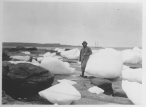 Image of [Man leaning on giant snow ball - ice floes]