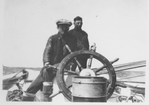 Image: [Two of the crew at the wheel]  ... and Ralph Robinson