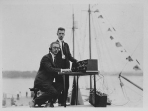 Image: [F.H. Schnell (l) and K. B. Warner (r) of ARRL  testing Wireless North Pole radio  (on the Bowdoin), on dock at Wiscasset next to the Bowdoin]