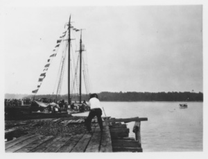 Image: The BOWDOIN, dressed, at dock. Large crowd