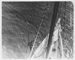 Image: [Man climbing rigging as seen from above]