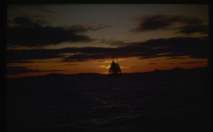Image: Fishing schooner against sunset sky.