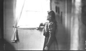 Image: Eskimo [Inuit] girl looking out window