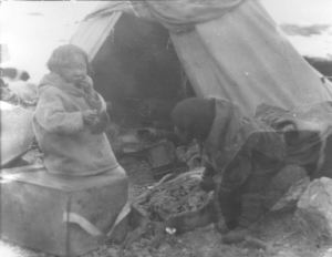 Image: Eskimo [Inuk] child eating raw meat