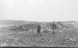 Image of Goddard and Abram carrying rocks