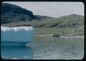 Image of Iceberg. Frame house by shore
