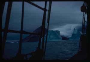 Image of Iceberg through rigging with fog back beyond
