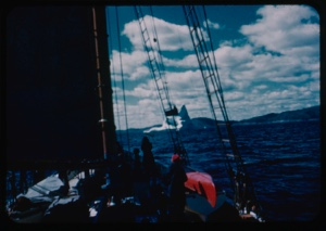 Image of Iceberg and clouds through rigging; Miriam MacMillan on deck