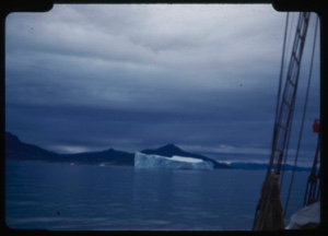 Image of Iceberg beyond rigging; storm clouds
