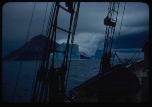 Image of Icebergs through rigging; storm clouds