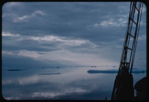 Image of Scattered ice, calm water, and reflections, through rigging