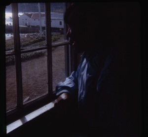 Image: Eskimo [Inuk] man looking out window