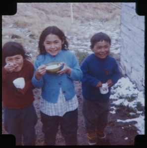 Image of Three Eskimo [Inuit] children, eating