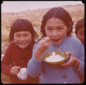 Image of Three Eskimo [Inuit] children, eating