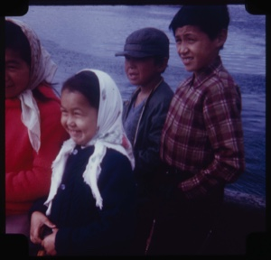 Image of Eskimo [Inuit] woman and three children in a boat