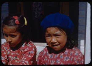 Image of Two Eskimo [Inuit] girls sitting on steps