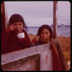 Image of Two Eskimo [Inuit] girls, eating