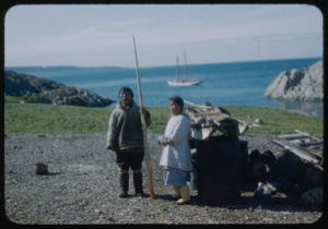 Image of Eskimo [Inuit] couple; man holding tusk; Bowdoin beyond